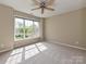 This comfortable bedroom features a ceiling fan and a large window for natural light at 6112 Swanston Dr, Charlotte, NC 28269