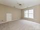 Spacious carpeted bedroom with a ceiling fan, large window, and closet at 6112 Swanston Dr, Charlotte, NC 28269