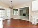 Bright dining area with hardwood floors, french doors, and view to living room with fireplace at 6112 Swanston Dr, Charlotte, NC 28269