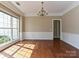 Elegant dining room with hardwood floors, wainscoting, a large window, and a classic chandelier at 6112 Swanston Dr, Charlotte, NC 28269