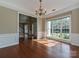 Bright dining room featuring hardwood floors, wainscoting, a chandelier, and entry view into the foyer at 6112 Swanston Dr, Charlotte, NC 28269