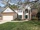 Charming two-story home featuring a brick facade, white columns, a green front door, and a well-maintained lawn at 6112 Swanston Dr, Charlotte, NC 28269