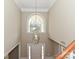 Grand foyer features a soaring ceiling, chandelier, and arched window over the front door at 6112 Swanston Dr, Charlotte, NC 28269