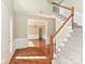 Inviting foyer with hardwood floors, staircase, and view into the formal dining room with classic wainscoting at 6112 Swanston Dr, Charlotte, NC 28269