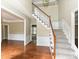 Elegant foyer features hardwood floors, a staircase with carpet runner, and classic wainscoting for a grand entry at 6112 Swanston Dr, Charlotte, NC 28269