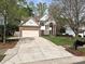 Charming brick and siding home featuring a large driveway and manicured lawn at 6112 Swanston Dr, Charlotte, NC 28269