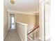 Upstairs hallway featuring neutral paint, carpet flooring, wooden staircase and modern lighting at 6112 Swanston Dr, Charlotte, NC 28269