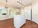 Bright eat-in kitchen with white cabinets, a functional island, and a view into the adjacent living space at 6112 Swanston Dr, Charlotte, NC 28269