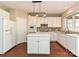 Bright kitchen featuring white cabinetry, a central island, and an eat-in area with natural lighting at 6112 Swanston Dr, Charlotte, NC 28269