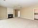 Spacious living room with fireplace, neutral paint, carpet flooring, and ceiling fan at 6112 Swanston Dr, Charlotte, NC 28269