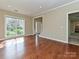 Bright living room with hardwood floors, large window, and open doorway leading to the entry way at 6112 Swanston Dr, Charlotte, NC 28269