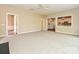 Expansive living room featuring plush carpeting, a ceiling fan, and views into the kitchen and another room at 6112 Swanston Dr, Charlotte, NC 28269