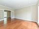 Spacious living room featuring hardwood floors, large windows, and French doors leading to an additional room at 6112 Swanston Dr, Charlotte, NC 28269