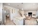 Bright open kitchen features stainless appliances, granite island, white cabinets, and adjacent living spaces at 710 Anglin Forest Way, Charlotte, NC 28214