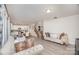 Spacious living room open to kitchen and staircase, featuring hardwood floors and stylish, comfortable seating at 710 Anglin Forest Way, Charlotte, NC 28214
