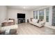 Bright living room with hardwood floors, neutral walls, stylish furnishings, and large window for natural light at 710 Anglin Forest Way, Charlotte, NC 28214