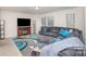 Comfortable living room with a large sectional sofa, modern rug, and entertainment center at 710 Anglin Forest Way, Charlotte, NC 28214