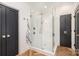 Bathroom showing frameless glass shower with brass hardware and herringbone floors at 728 Brookside Ave, Charlotte, NC 28203