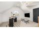 Attic bonus room with round window, desk area, and mounted television at 728 Brookside Ave, Charlotte, NC 28203