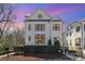 Elegant white brick home showcasing large windows, refined landscaping, and inviting curb appeal at 728 Brookside Ave, Charlotte, NC 28203