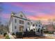 Stunning exterior view of white brick homes against a vibrant sky with a well-manicured lawn at 728 Brookside Ave, Charlotte, NC 28203