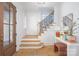 Inviting foyer features a staircase, wood floors, shiplap and wood front door at 728 Brookside Ave, Charlotte, NC 28203
