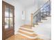 Bright foyer with wood floors, shiplap walls, and a staircase with modern railing at 728 Brookside Ave, Charlotte, NC 28203