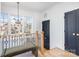 Bright hallway with natural light, wooden banister, and modern chandelier at 728 Brookside Ave, Charlotte, NC 28203