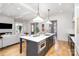 Modern kitchen features a spacious island, stainless steel appliances, and seamless flow into living space at 728 Brookside Ave, Charlotte, NC 28203