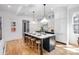 This kitchen boasts an island with a breakfast bar, modern appliances, and stylish pendant lighting at 728 Brookside Ave, Charlotte, NC 28203