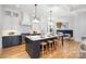 Spacious kitchen featuring a large island with seating, white cabinetry, and stainless steel appliances at 728 Brookside Ave, Charlotte, NC 28203