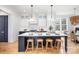 Bright kitchen features a large island with seating, white cabinetry, and modern stainless steel appliances at 728 Brookside Ave, Charlotte, NC 28203