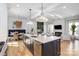 Open-concept kitchen and living room with large island, modern appliances, and ample natural light at 728 Brookside Ave, Charlotte, NC 28203