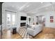 Open-concept living room with a fireplace, hardwood floors, and access to the staircase at 728 Brookside Ave, Charlotte, NC 28203
