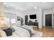 Bright main bedroom with modern lighting, TV, and an upholstered bench at 728 Brookside Ave, Charlotte, NC 28203