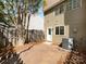 Private backyard with brick patio, fenced yard, and mature trees at 7301 Pebblestone Dr # F, Charlotte, NC 28212