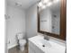 Well-lit bathroom with a modern vanity, large mirror, tiled floors, and a shower and tub combo at 7301 Pebblestone Dr # F, Charlotte, NC 28212