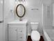 Bright bathroom features a white vanity, an oval gold mirror, and a clean, modern toilet and shower at 7301 Pebblestone Dr # F, Charlotte, NC 28212