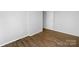 Clean, minimalist bedroom with laminate flooring and a neutral color palette at 7301 Pebblestone Dr # F, Charlotte, NC 28212