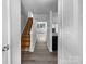 Inviting entryway with hardwood floors and staircase leads to a bright, open living space at 7301 Pebblestone Dr # F, Charlotte, NC 28212