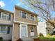 Charming two-story townhome featuring light brown siding, white trim, and manicured front yard landscaping at 7301 Pebblestone Dr # F, Charlotte, NC 28212