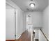 Upstairs hallway with hardwood floors leading to bedrooms and closet space at 7301 Pebblestone Dr # F, Charlotte, NC 28212