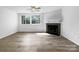 Bright, open living room with fireplace, large windows and neutral decor, perfect for relaxation at 7301 Pebblestone Dr # F, Charlotte, NC 28212