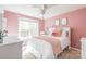 Charming pink bedroom featuring a plush bed and bright natural light at 7353 Sedgebrook W Dr, Stanley, NC 28164