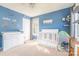 Cozy blue Bedroom with crib, changing table, and playful decor at 7353 Sedgebrook W Dr, Stanley, NC 28164