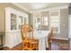 Elegant dining area with hardwood floors, large windows, and stylish décor at 7353 Sedgebrook W Dr, Stanley, NC 28164