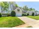 Charming home with a lush green lawn, attached garage, and inviting curb appeal at 7353 Sedgebrook W Dr, Stanley, NC 28164