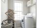 Well-equipped laundry room with modern washer and dryer, and ample storage at 7353 Sedgebrook W Dr, Stanley, NC 28164