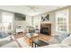 Inviting living room with a fireplace, large windows, and comfortable seating at 7353 Sedgebrook W Dr, Stanley, NC 28164