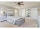 Spacious main bedroom with a ceiling fan, neutral decor, and large windows at 7353 Sedgebrook W Dr, Stanley, NC 28164